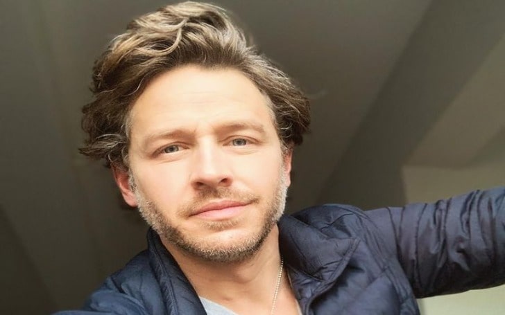 Josh Dallas in a blue jacket.